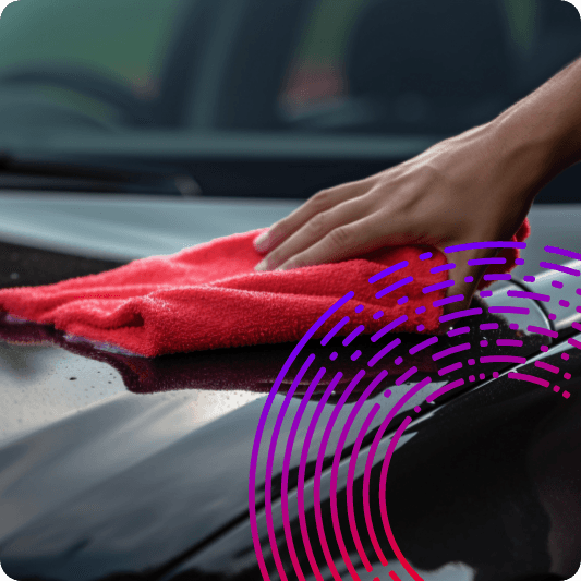 Someone wiping a dashboard with a cloth